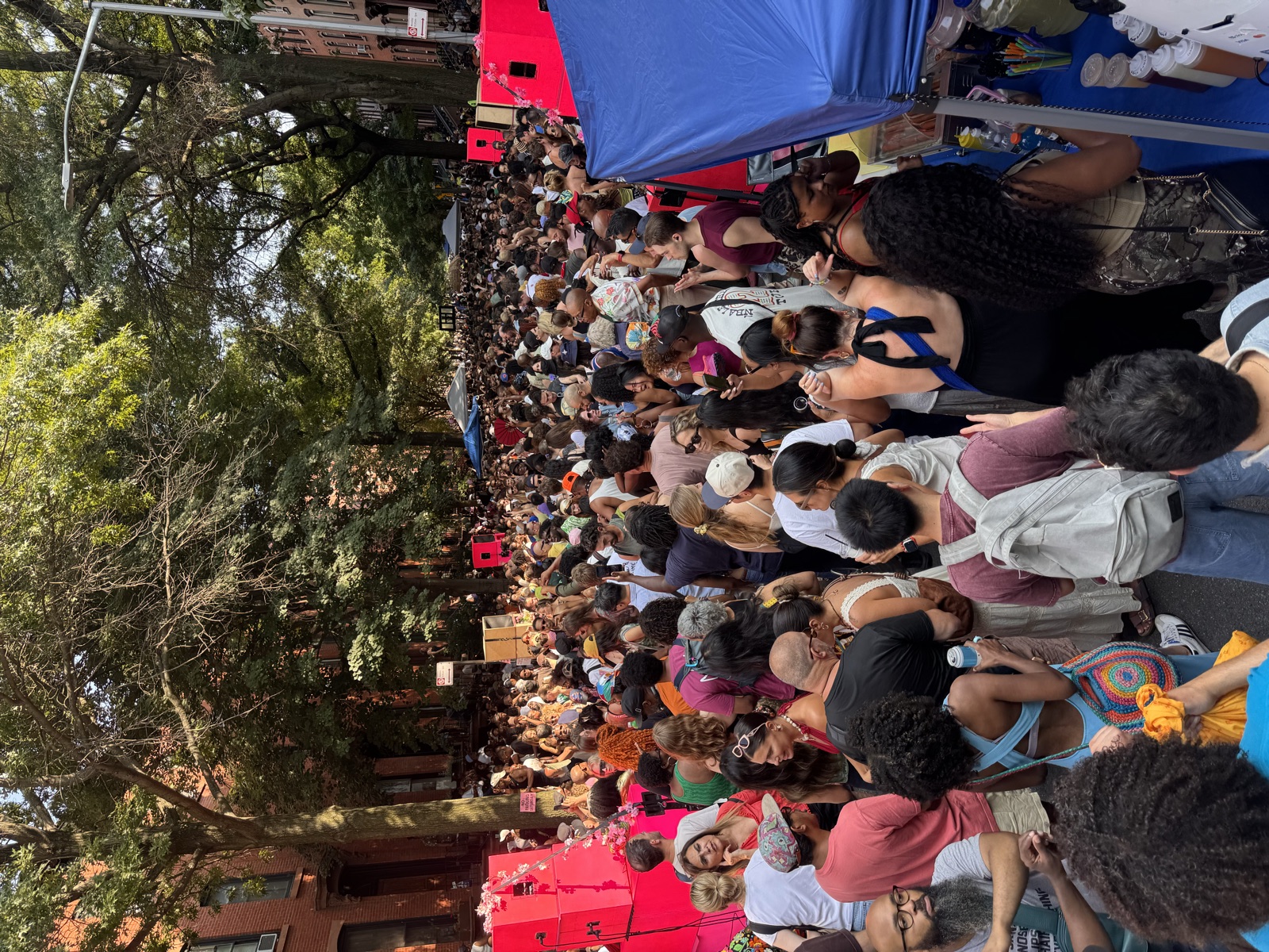 Crowd gathered around the pink stacks at a street festival