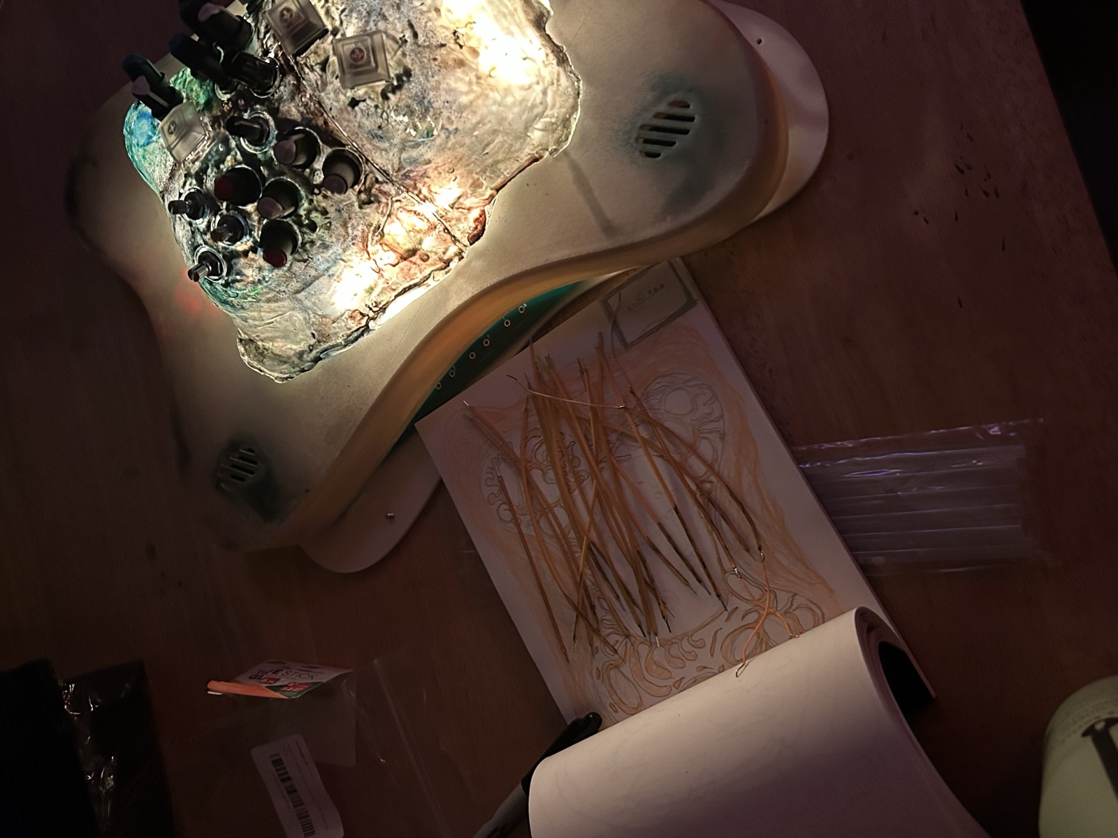 Serenity Synth on the workbench with sketches and dried stems